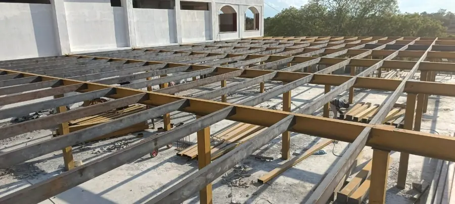 Steel beam grid and secondary members prepared for roofing or deck installation.