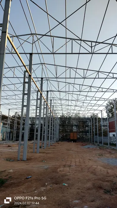 Tall industrial shed frame with multiple steel columns and roof trusses.