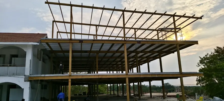 Steel roof extension frame fabricated above an existing multi-storey building.